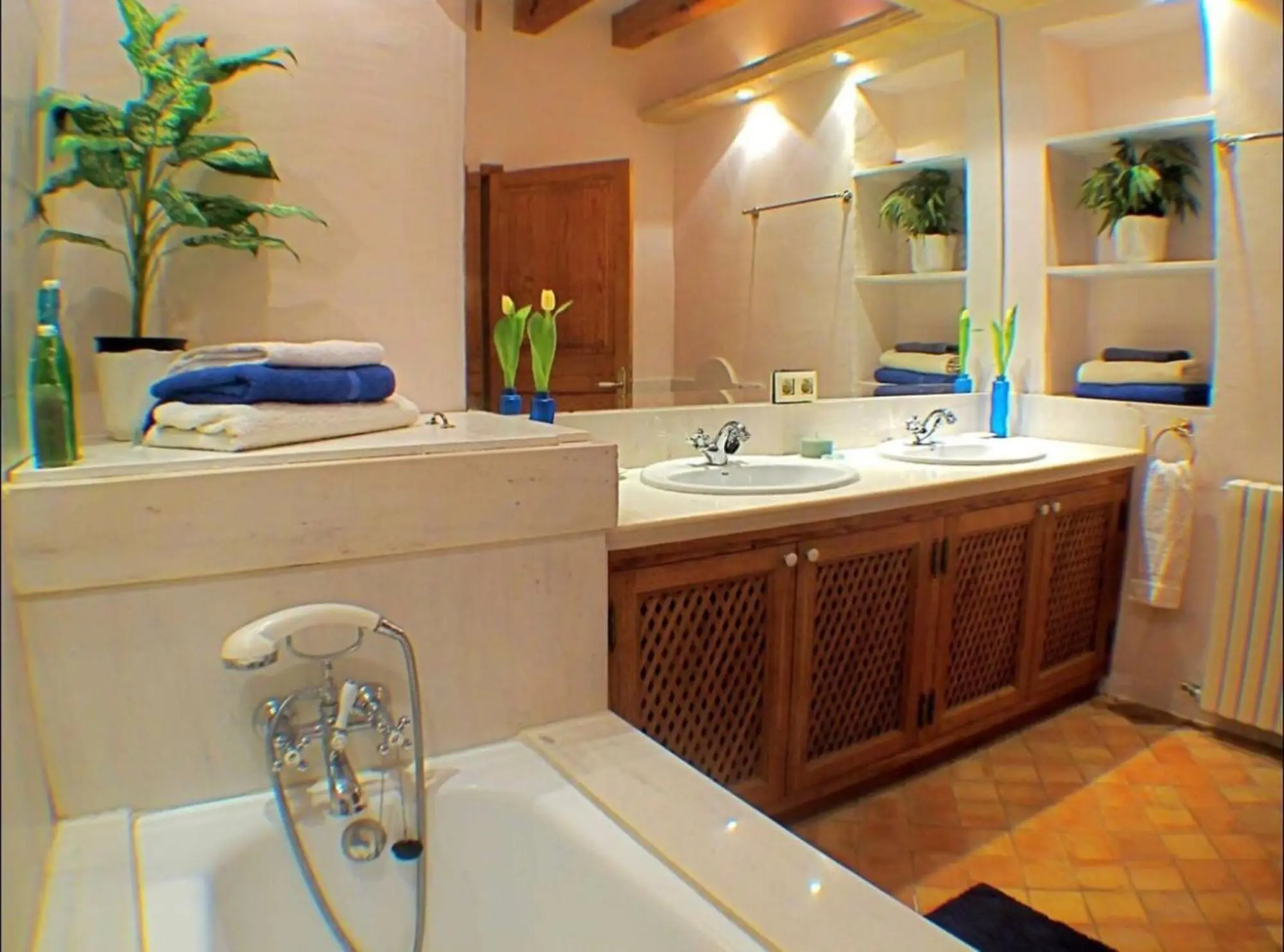Bathroom with a built double vanity and tub