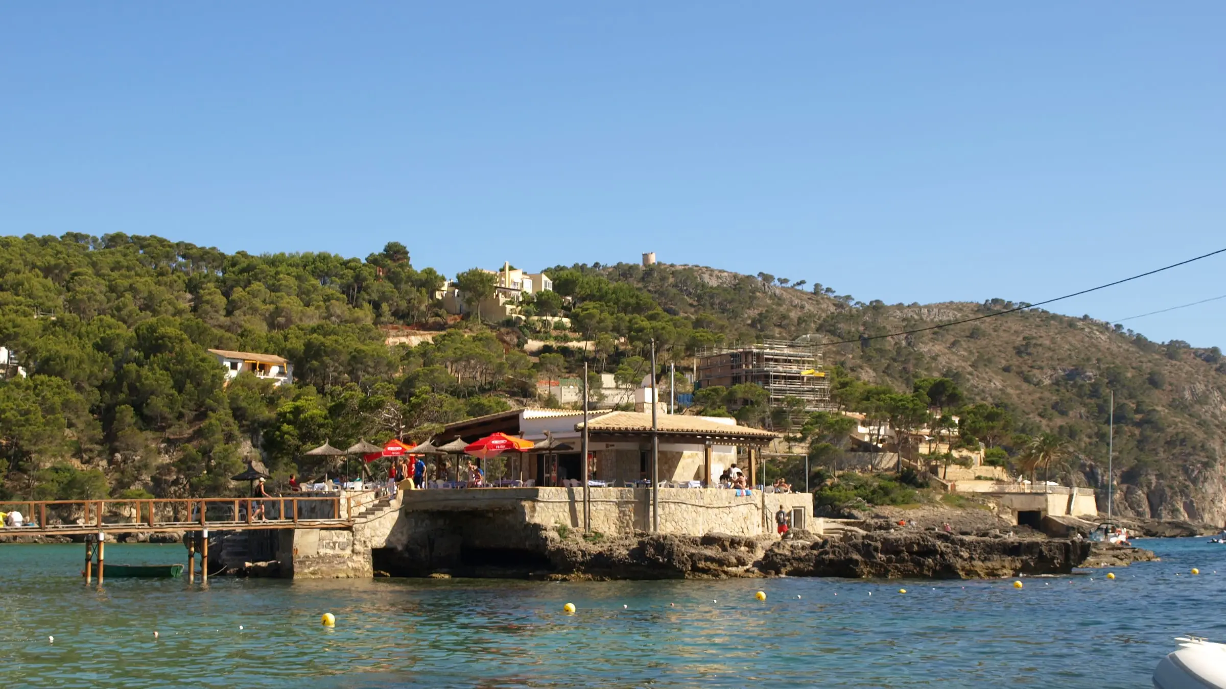 The Illeta in the bay of Camp de Mar with its restaurant and the wooden jetty to the beach