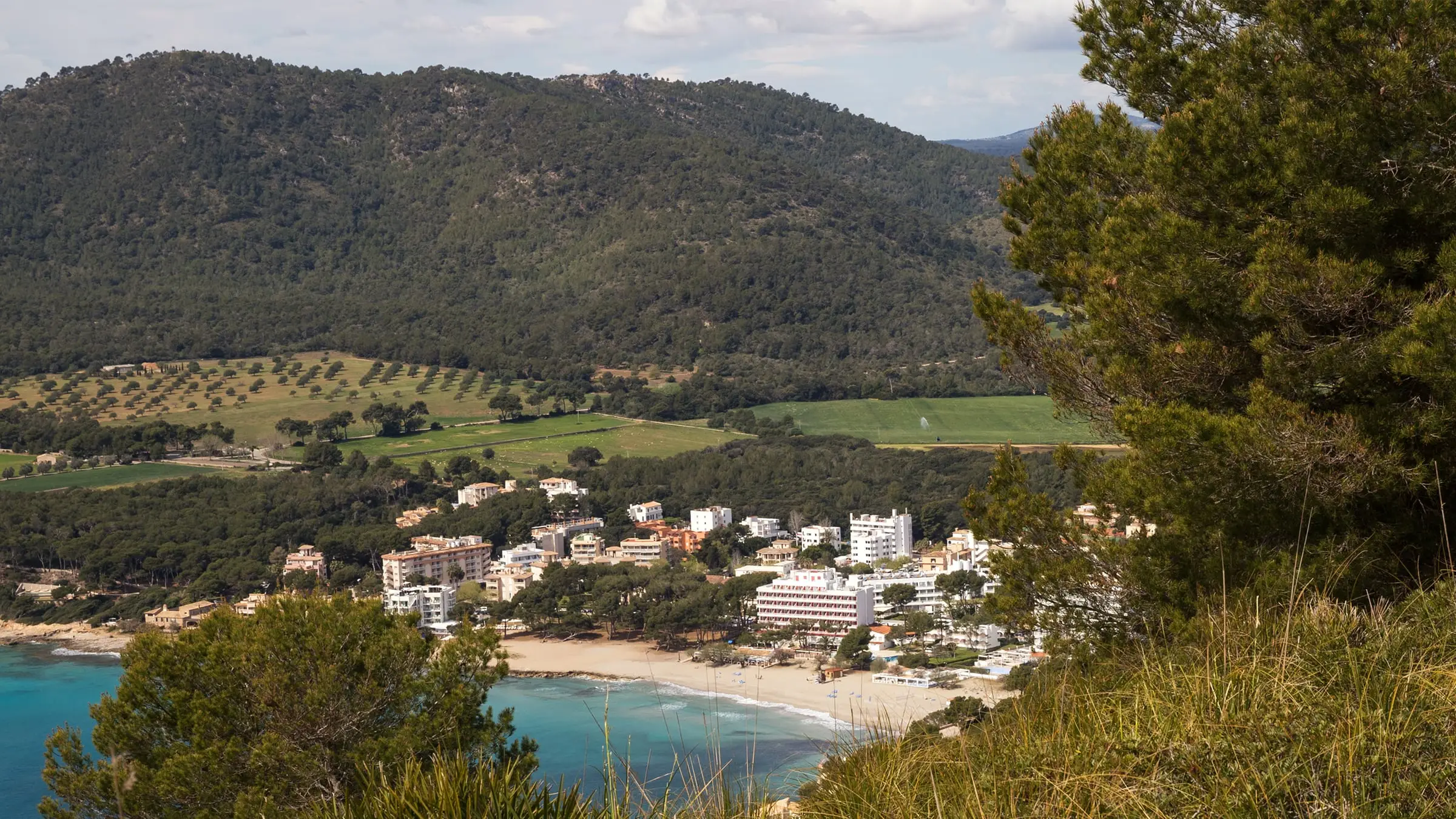 View from Cap Vermell over Canyamel: beach, town and the undeveloped valley behind