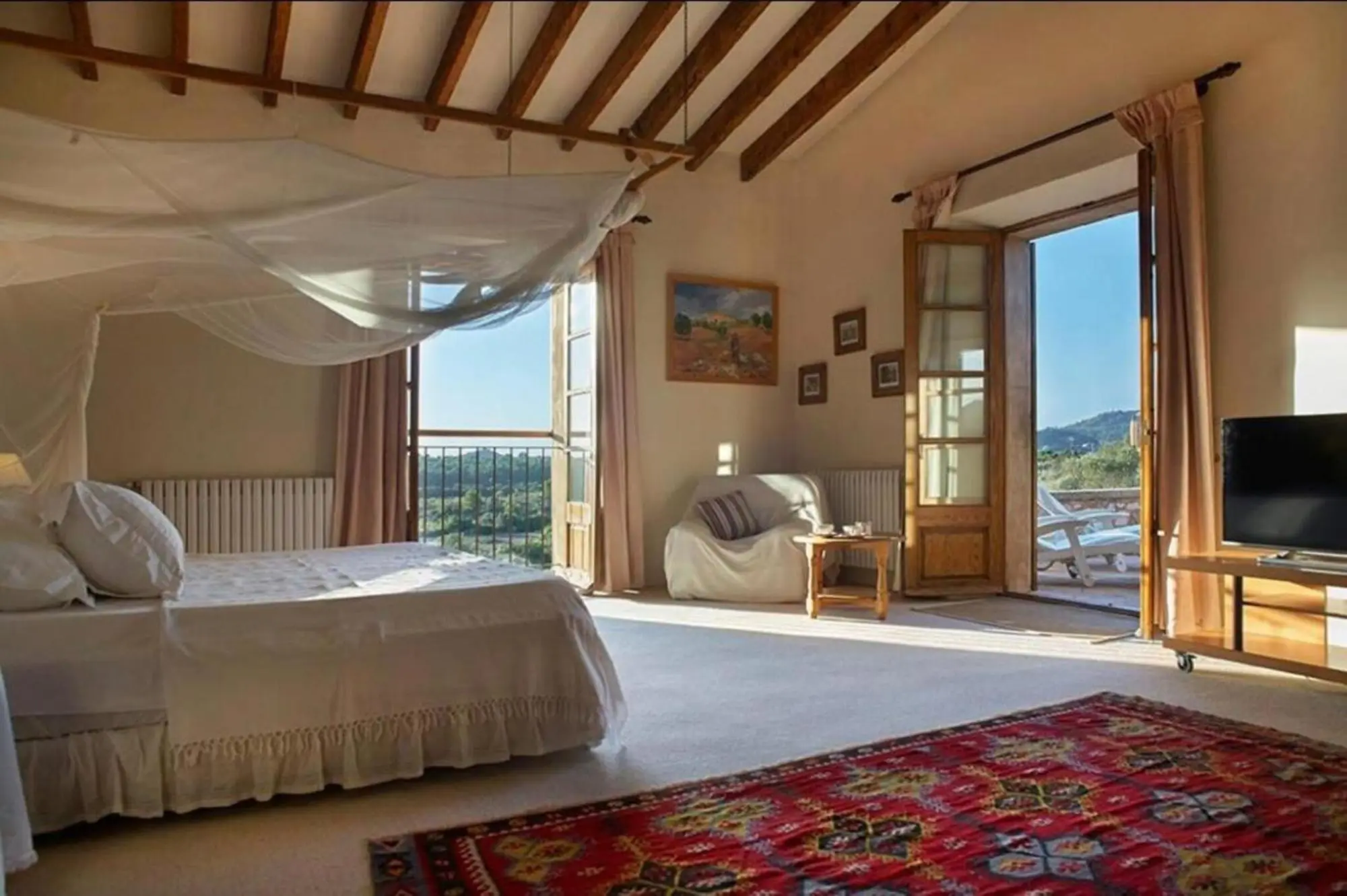 Bedroom with four-poster bed and French doors onto the terrace