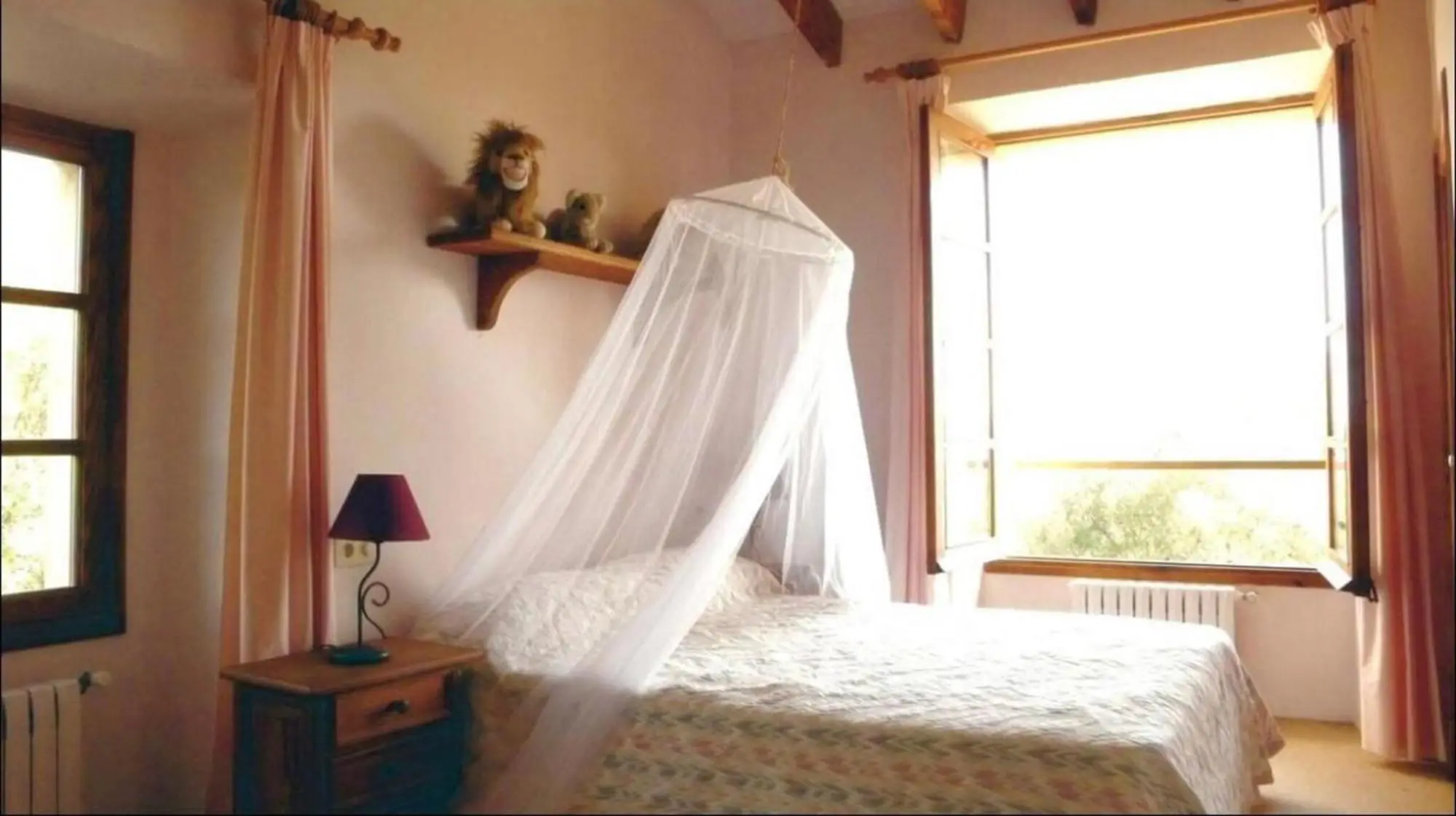 Bedroom with two single beds under mosquito nets
