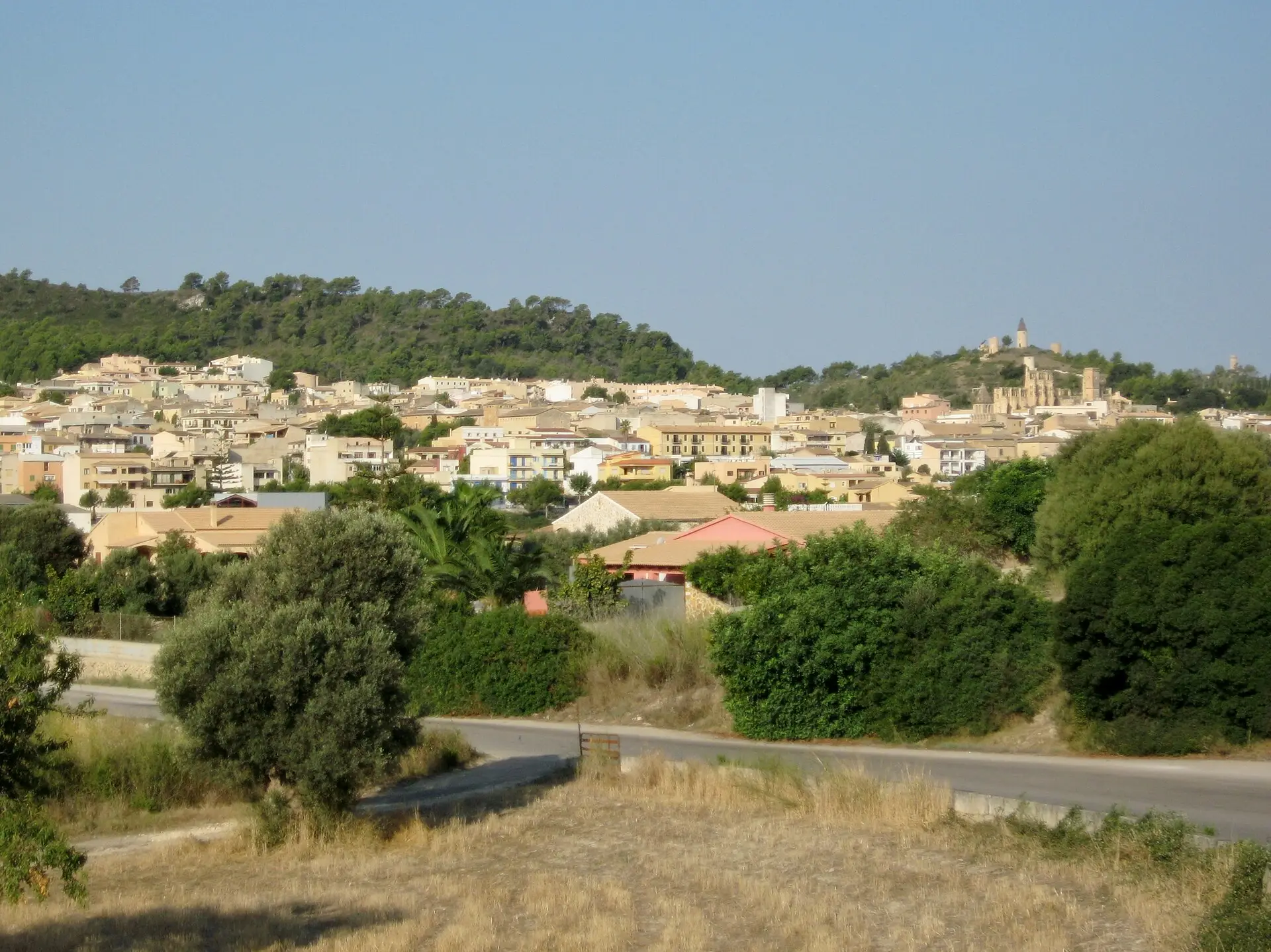 View over the rooftops of Son Servera, the unfinished Església Nova on the hillside to the right