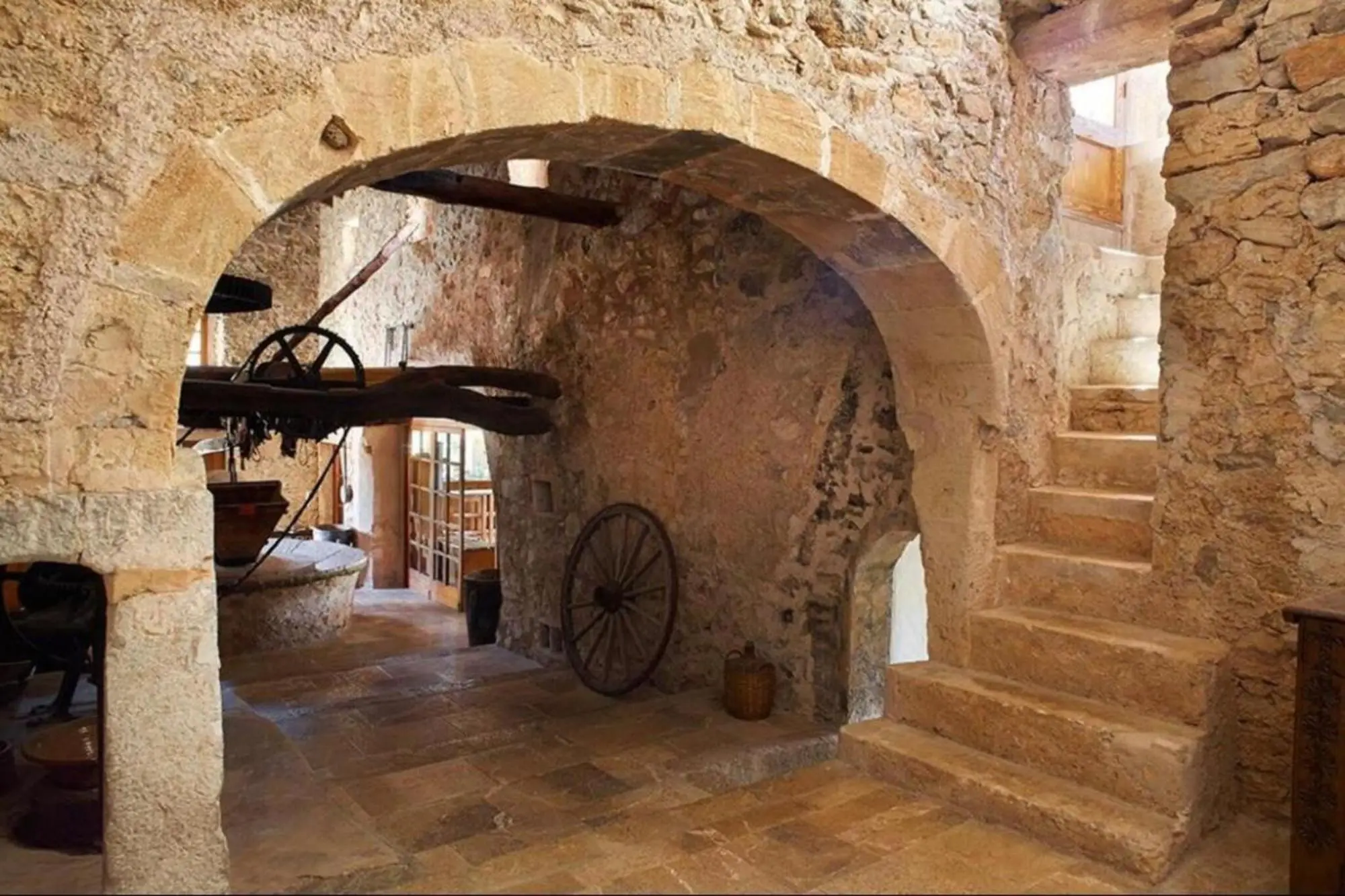 Historic stone arch over the passage, beside it a built stone staircase