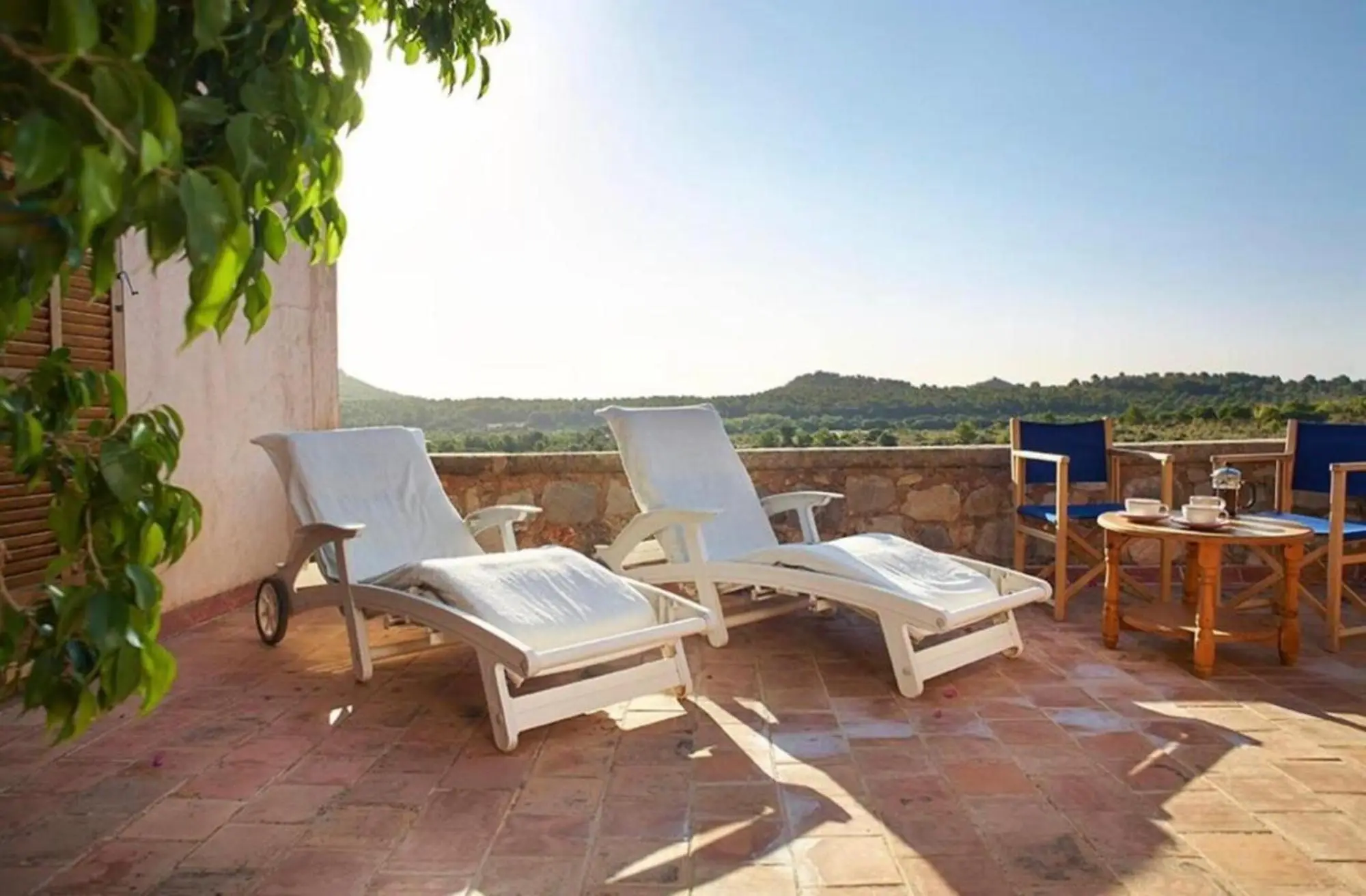 Terrace with sun loungers and seating, a view across the estate’s own land