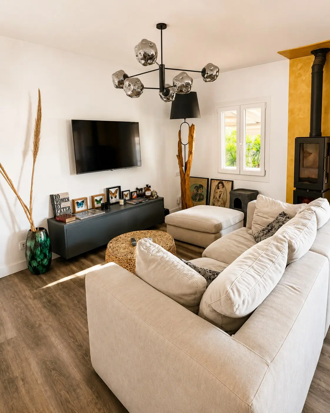 Living room with sofa, wood-burning stove and designer pendant
